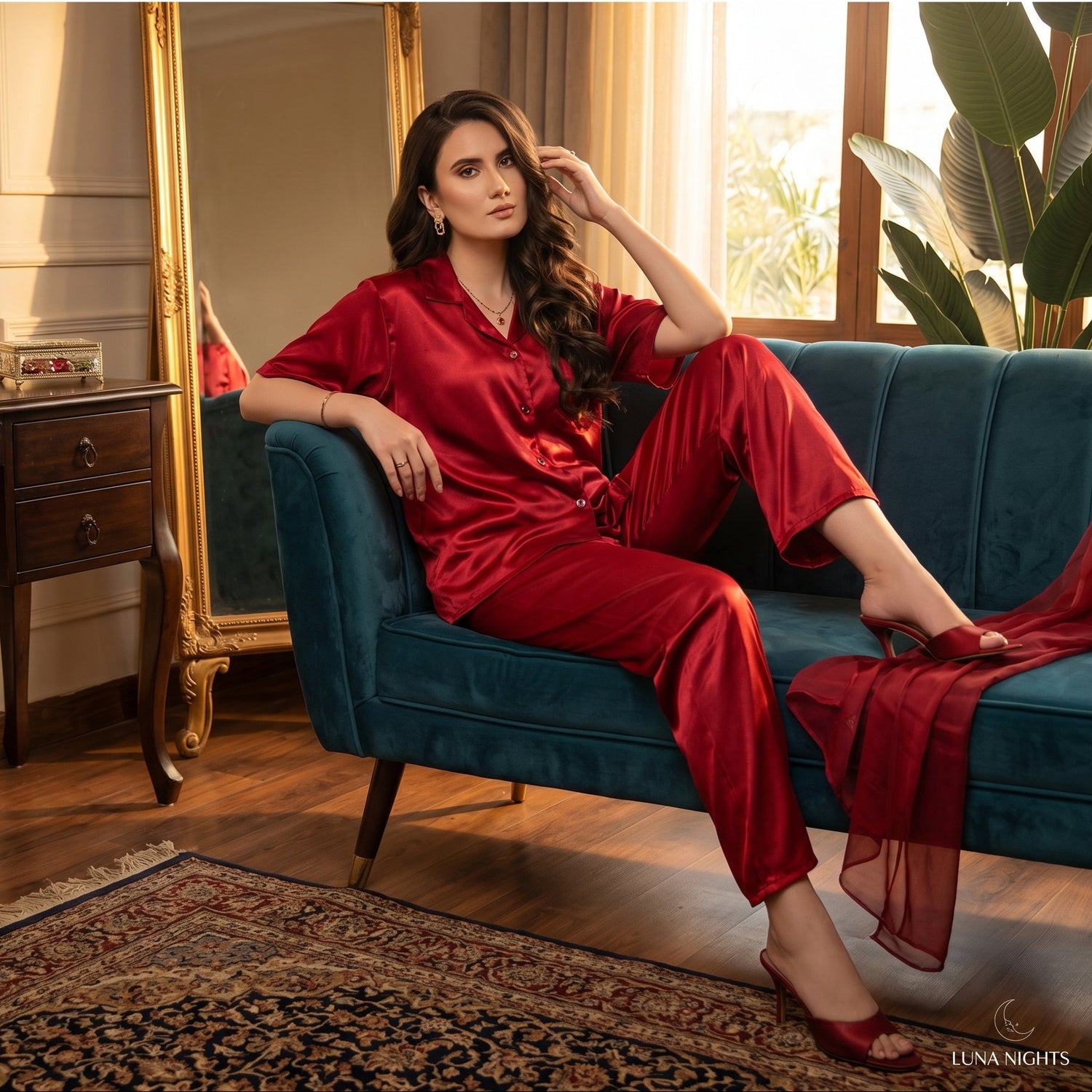 Woman in red outfit sitting on a blue couch with 'The Ruby Hours Collection' text above.